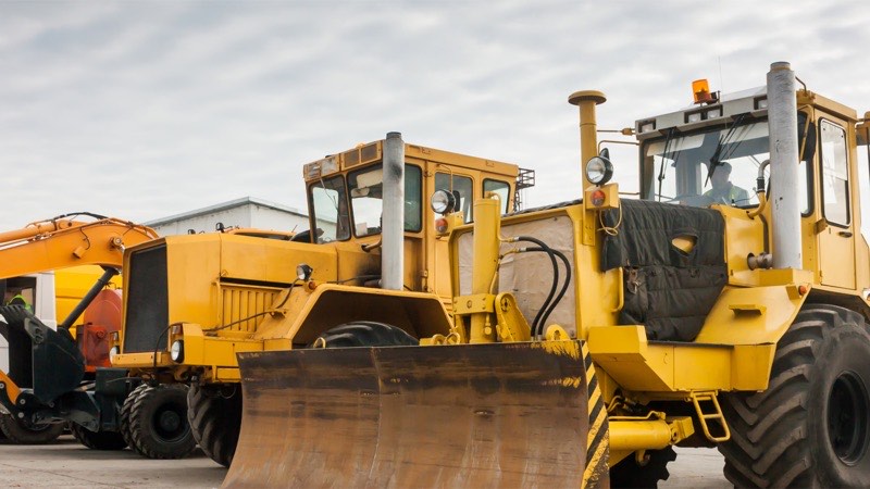 Heavy equipment staged in a dealer yard